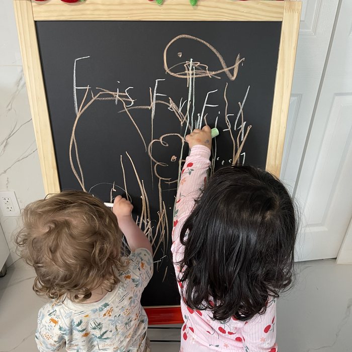 Children drawing at the chalkboard