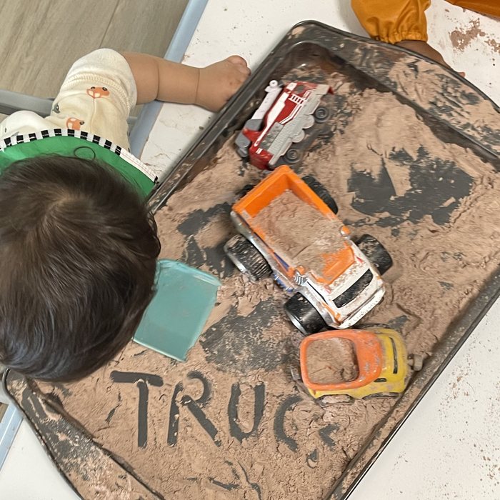 Sensory tray with trucks